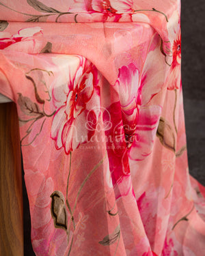 A floral chiffon georgette saree in light pink paired with a simple pink mirror work blouse