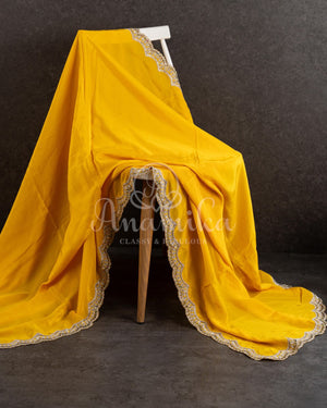 Yellow pure crepe saree with handwork scallop border