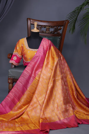 A rich kanjeevaram silk saree in yellow and pink dual tone