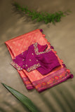 A beautiful kanjeevaram saree in peach with resham thread work floral border
