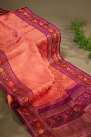 A beautiful kanjeevaram saree in peach with resham thread work floral border