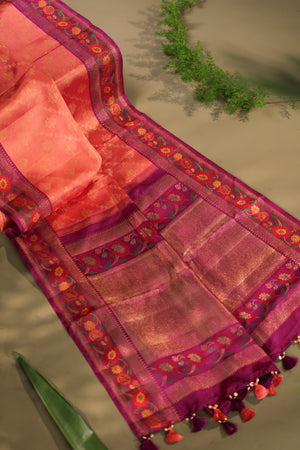 A beautiful kanjeevaram saree in peach with resham thread work floral border