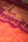 A beautiful kanjeevaram saree in peach with resham thread work floral border