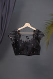 A lovely soft silk floral saree in black with a mirror work blouse