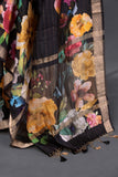 A lovely soft silk floral saree in black with a mirror work blouse