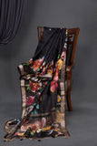 A lovely soft silk floral saree in black with a mirror work blouse