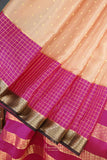 A beautiful mysore crepre silk saree in soft peach and rani pink combination