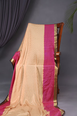 A beautiful mysore crepre silk saree in soft peach and rani pink combination