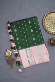 A designer kanjeevaram saree in bottle green with hues of pink border and pallu