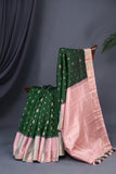 A designer kanjeevaram saree in bottle green with hues of pink border and pallu