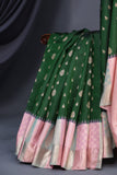 A designer kanjeevaram saree in bottle green with hues of pink border and pallu