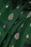 A designer kanjeevaram saree in bottle green with hues of pink border and pallu