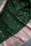 A designer kanjeevaram saree in bottle green with hues of pink border and pallu