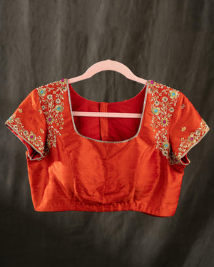 Mustard yellow organza saree with a contrast orange blouse