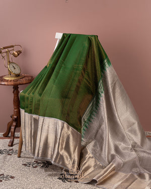 Dark green kanjeevaram saree with contrast grey border and pallu