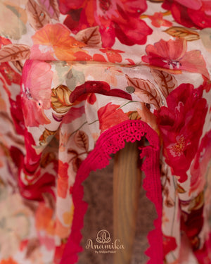 Beige Floral Chinnon saree with a contrast tomato pink handwork blouse