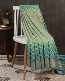 A Bandini Georgette saree in hues of blue paired with a blue pearl work blouse