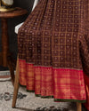 Brown kanjeevaram saree with a contrast dark pink border and Patola blouse