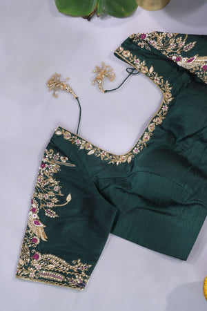 An exquisite kanjeevaram saree in deep maroon and emerald green combo