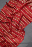 A striking red Mashru silk saree with a designer blouse