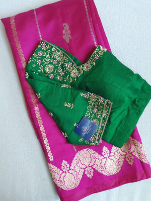 Raw  mango Pattu saree in hot pink paired with a contrast green blouse.