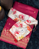 Raw mango pattu saree in a lovely shade of pink paired with a contrast floral blouse