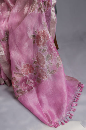A beautiful rose pink tissue saree with an off white blouse