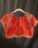 Mustard yellow organza saree with a contrast orange blouse