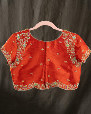 Mustard yellow organza saree with a contrast orange blouse