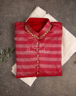 Lovely red silk kurta with Zari lines and hand embroidery across the neckline.