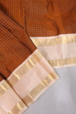 A beautiful vintage kanjeevaram in coppery rust with an ivory border