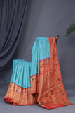 Aqua blue Gadwal saree with meenakari floral border in orange