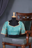 A classic patola in aqua blue with a striking contrast red