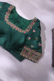 Raw Mango saree in bubble gum pink paired with a contrast dark green blouse