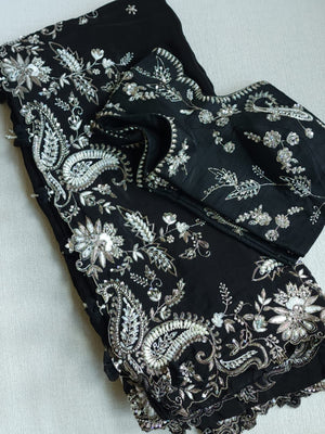 A pure crepe saree in black with stunning silver embroidered border