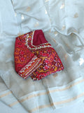Flowy Malai silk saree in grey paired with a red Patola blouse