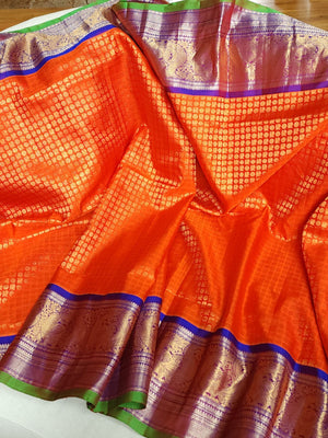 A grand Gadwal Kanchi saree in orange for your joyous occasions