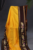 Yellow Gadwal Pattu saree with brown border and tanjore painting