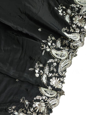 A pure crepe saree in black with stunning silver embroidered border