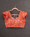Heavy embroidered Bridal Blouse in Orange with intricately designed cutwork neck and sleeves pattern