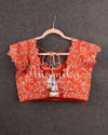 Heavy embroidered Bridal Blouse in Orange with intricately designed cutwork neck and sleeves pattern
