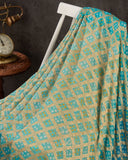 A Bandini Georgette saree in hues of blue paired with a blue pearl work blouse