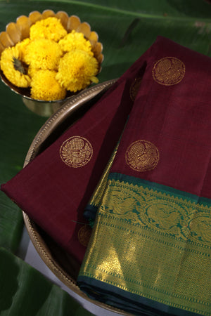 An exquisite kanjeevaram saree in deep maroon and emerald green combo