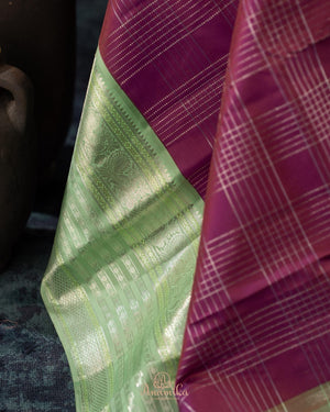 A kanjeevaram saree in purple with pastel green combo
