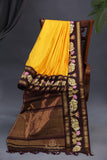 Yellow Gadwal Pattu saree with brown border and tanjore painting