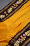 Yellow Gadwal Pattu saree with brown border and tanjore painting