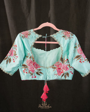 A beautiful Floral blouse in pastel blue with intricately designed embroidery