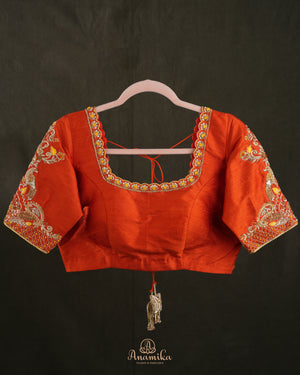 Kanchi soft silk saree in yellow paired with a contrast orange blouse