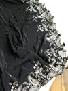 A pure crepe saree in black with stunning silver embroidered border