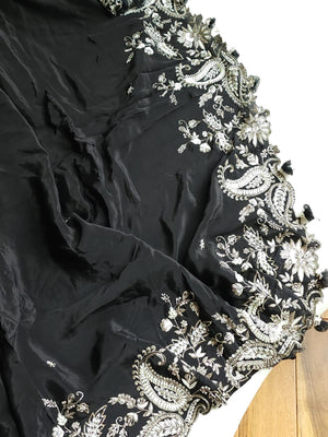 A pure crepe saree in black with stunning silver embroidered border